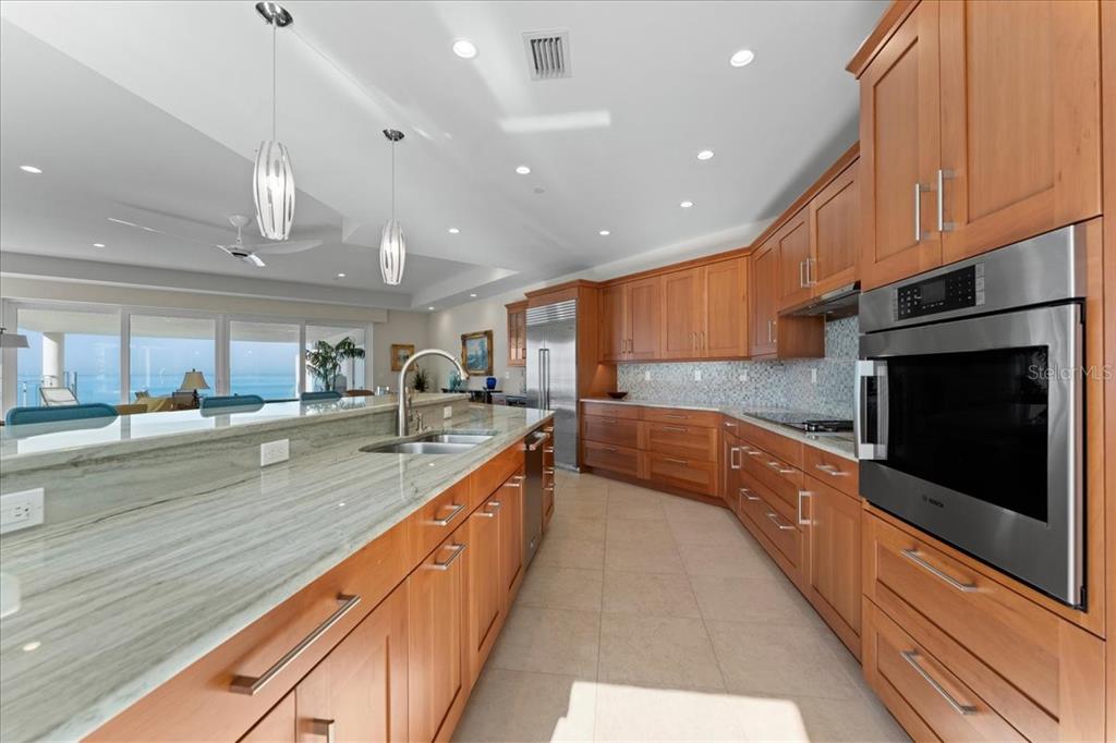 2708 North Beach Road, Unit 2 Englewood, FL 34223 - Photo 14 of 65 a large kitchen with stainless steel appliances granite countertop a large counter top a stove and a sink