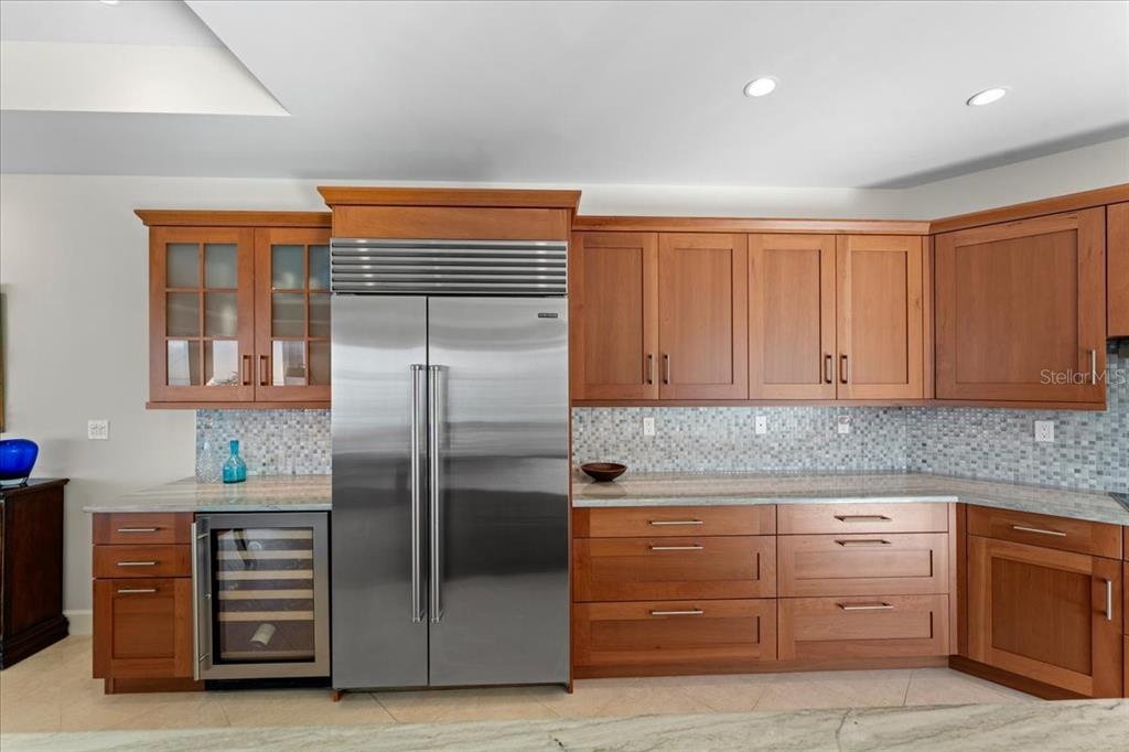 2708 North Beach Road, Unit 2 Englewood, FL 34223 - Photo 18 of 65 a kitchen with stainless steel appliances granite countertop a refrigerator and a stove
