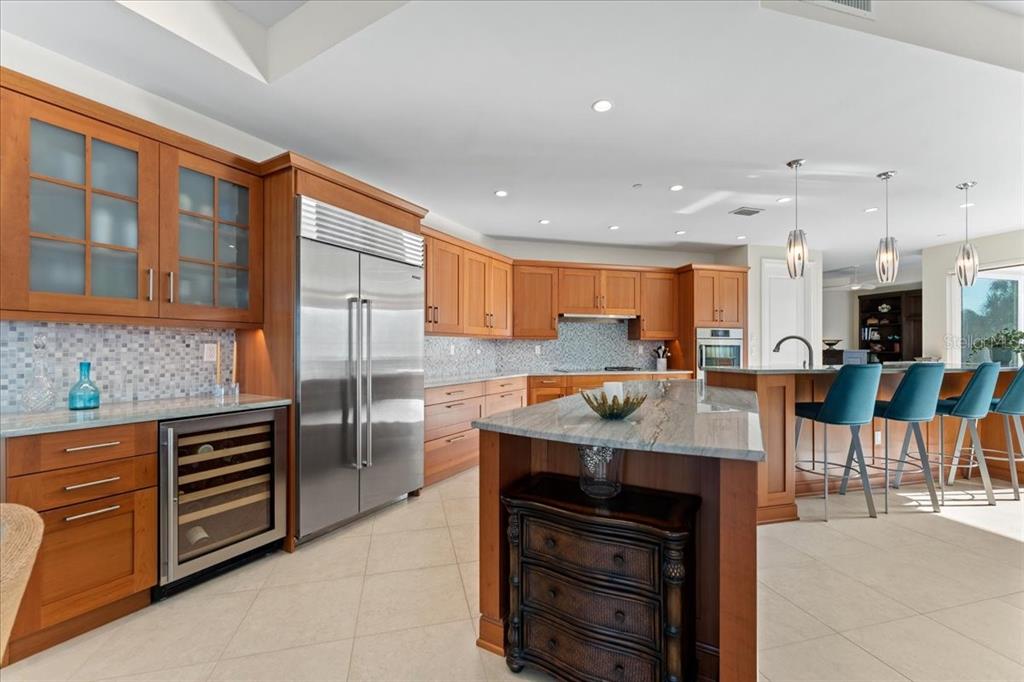 2708 North Beach Road, Unit 2 Englewood, FL 34223 - Photo 19 of 65 a kitchen with stainless steel appliances granite countertop a stove and a refrigerator