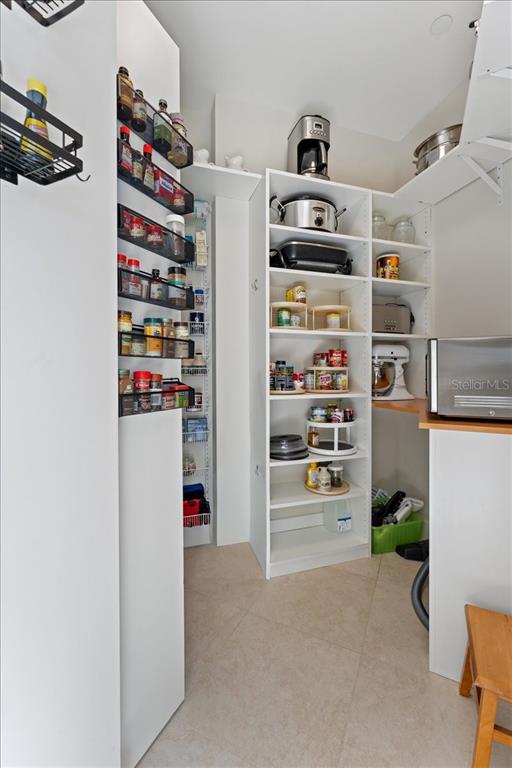 2708 North Beach Road, Unit 2 Englewood, FL 34223 - Photo 21 of 65 a view of walk in closet with clothes and shoes