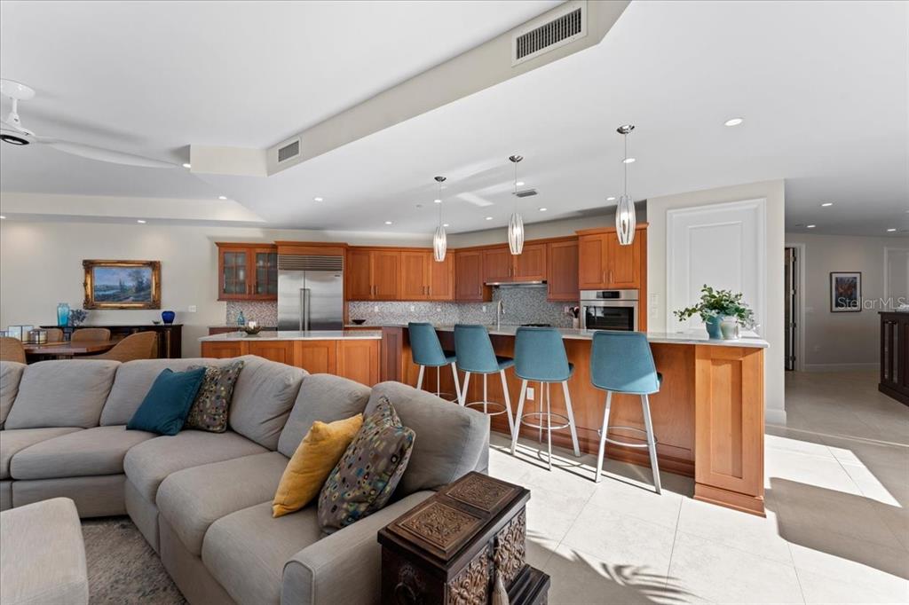 2708 North Beach Road, Unit 2 Englewood, FL 34223 - Photo 24 of 65 a living room with furniture kitchen view and a wooden floor