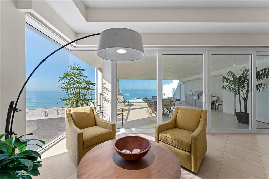 2708 North Beach Road, Unit 2 Englewood, FL 34223 - Photo 26 of 65 a living room with furniture and a chandelier