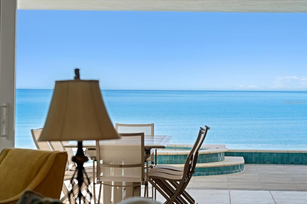 2708 North Beach Road, Unit 2 Englewood, FL 34223 - Photo 31 of 65 a lamp is sitting on a table and chair in the patio