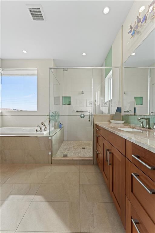 2708 North Beach Road, Unit 2 Englewood, FL 34223 - Photo 38 of 65 a large bathroom with a sink mirror and a bath tub