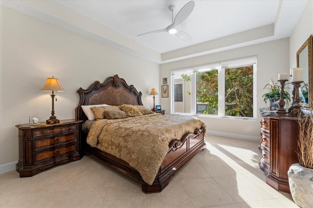 2708 North Beach Road, Unit 2 Englewood, FL 34223 - Photo 40 of 65 a spacious bedroom with a bed and large windows