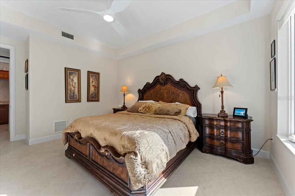 2708 North Beach Road, Unit 2 Englewood, FL 34223 - Photo 41 of 65 a spacious bedroom with a bed and window