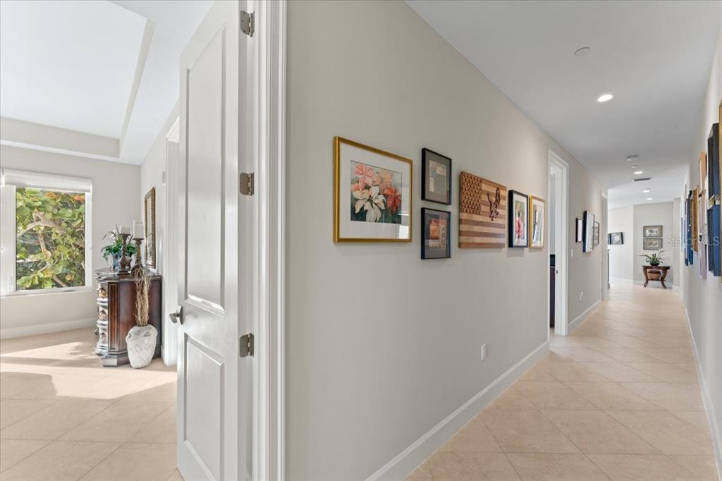 2708 North Beach Road, Unit 2 Englewood, FL 34223 - Photo 44 of 65 a view of a hallway with wooden floor and windows