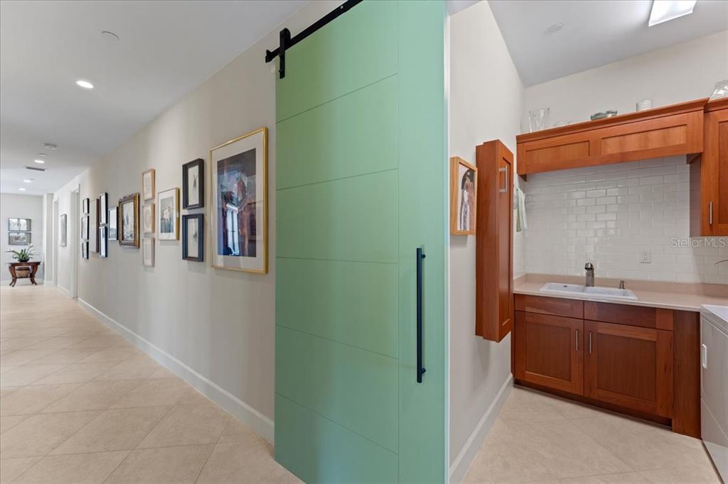 2708 North Beach Road, Unit 2 Englewood, FL 34223 - Photo 53 of 65 a bathroom with a double vanity sink and a mirror