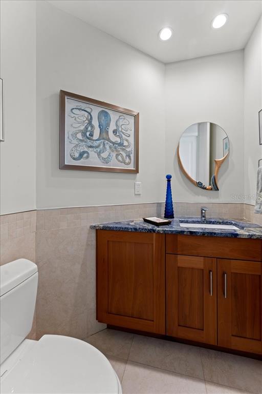 2708 North Beach Road, Unit 2 Englewood, FL 34223 - Photo 54 of 65 a bathroom with a toilet a sink and mirror