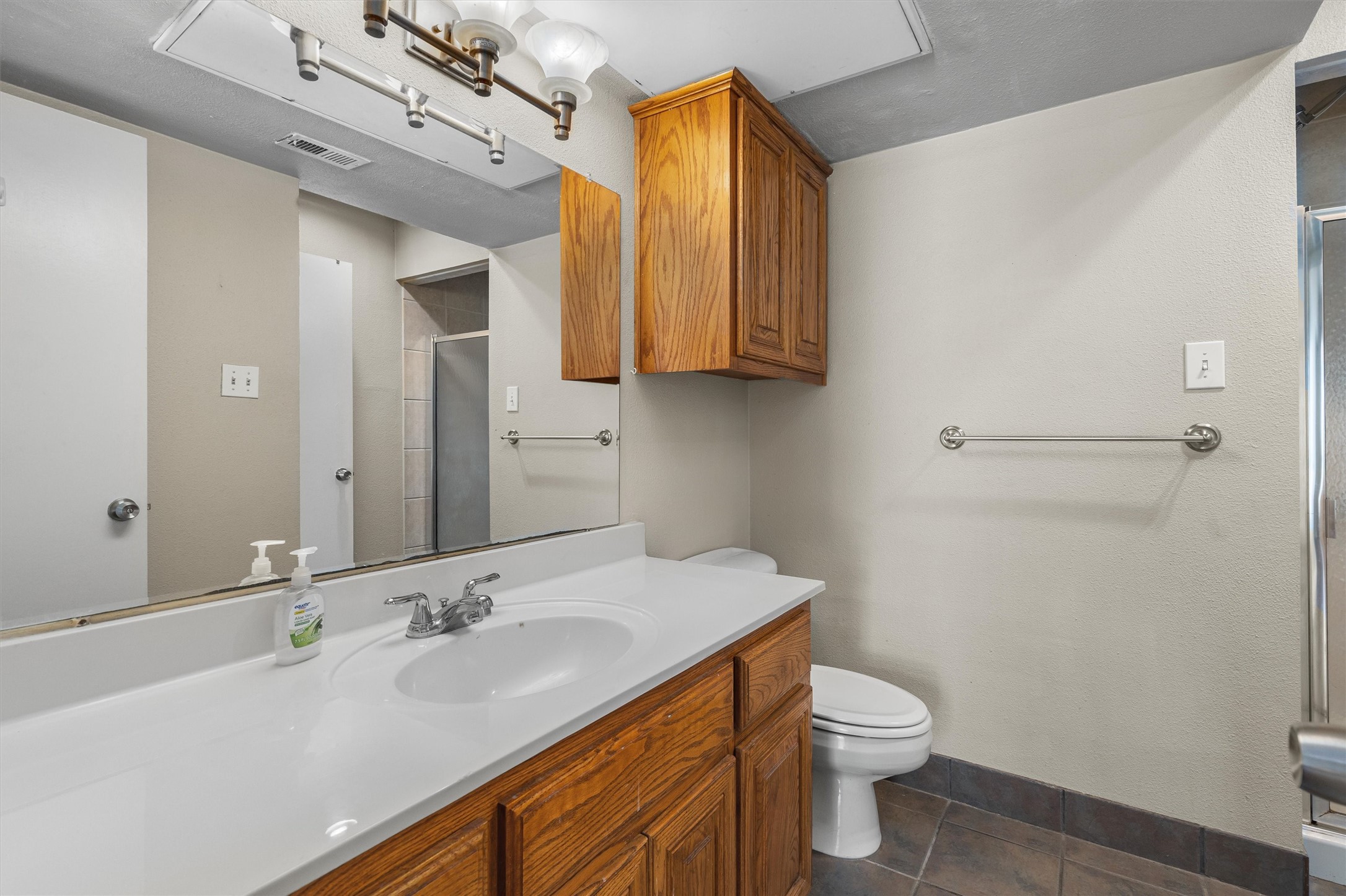 806 West 24th Street, Unit 326 Austin, TX 78705 - Photo 24 of 33 a bathroom with a sink a toilet and mirror