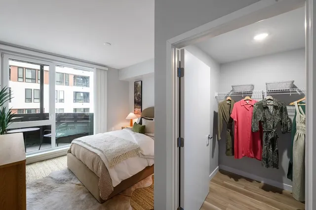 a bedroom with a bed and a large window