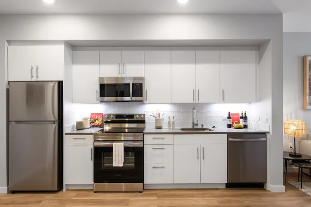 a kitchen with a refrigerator stove and microwave