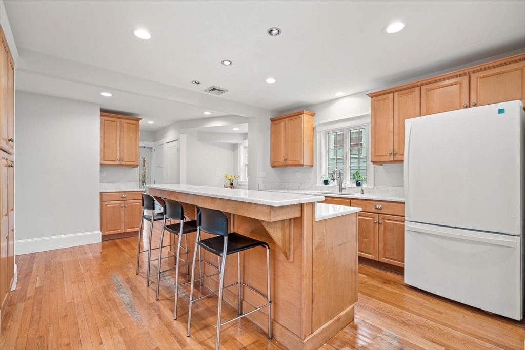 50 Allen Road Winchester, MA 01890 - Photo 13 of 29 a kitchen with stainless steel appliances a refrigerator a sink dishwasher a stove with white cabinets and wooden floor