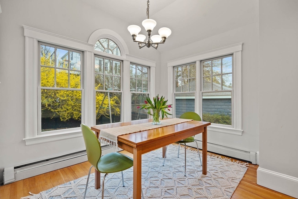 50 Allen Road Winchester, MA 01890 - Photo 14 of 29 a dining room with furniture a chandelier and wooden floor