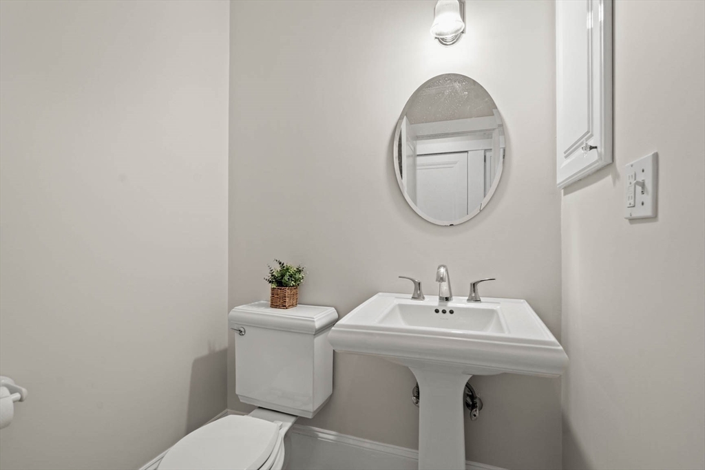 50 Allen Road Winchester, MA 01890 - Photo 16 of 29 a bathroom with a sink mirror and toilet