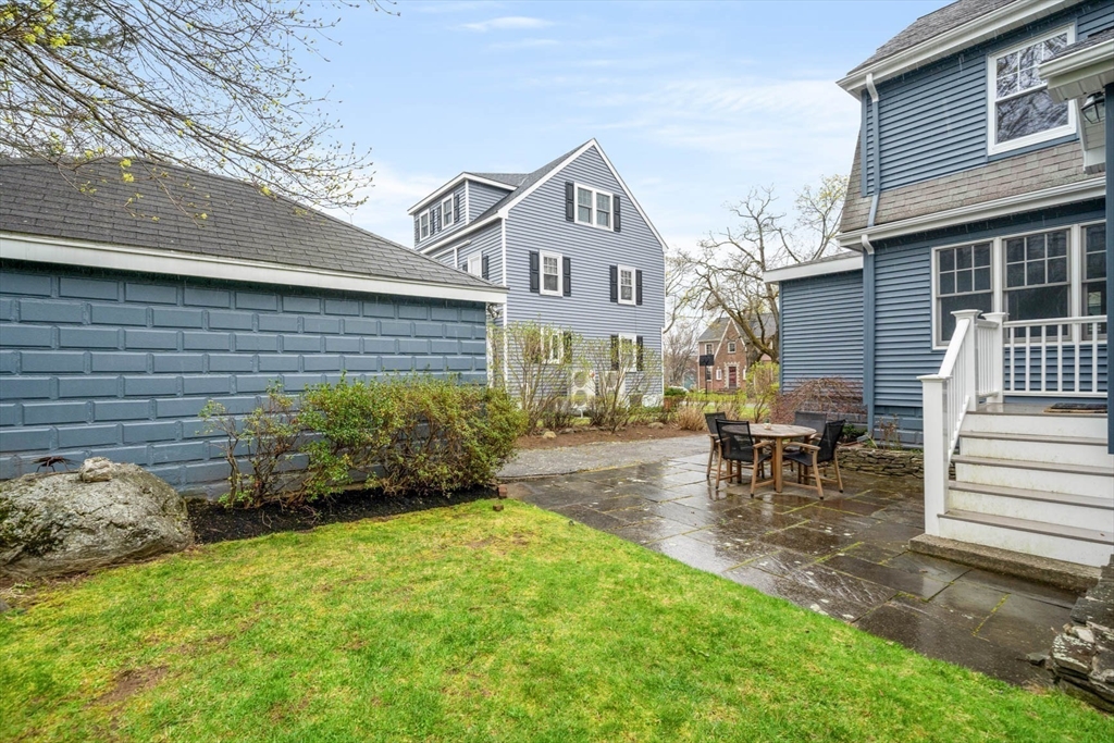 50 Allen Road Winchester, MA 01890 - Photo 26 of 29 a view of a patio with table and chairs with wooden fence and plants