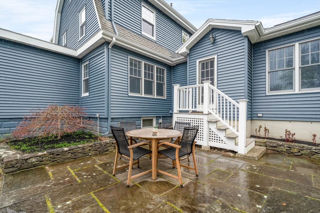 50 Allen Road Winchester, MA 01890 - Photo 3 of 29 a view of a patio with table and chairs and wooden fence