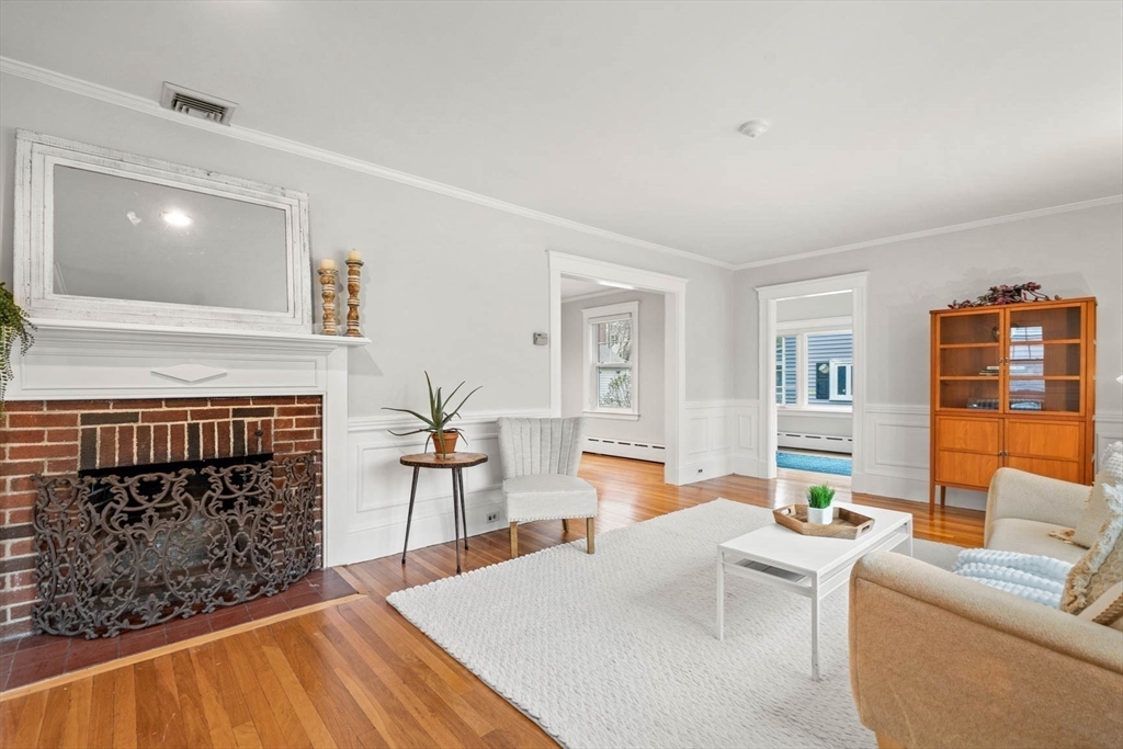 50 Allen Road Winchester, MA 01890 - Photo 6 of 29 a living room with furniture a fireplace and a flat screen tv