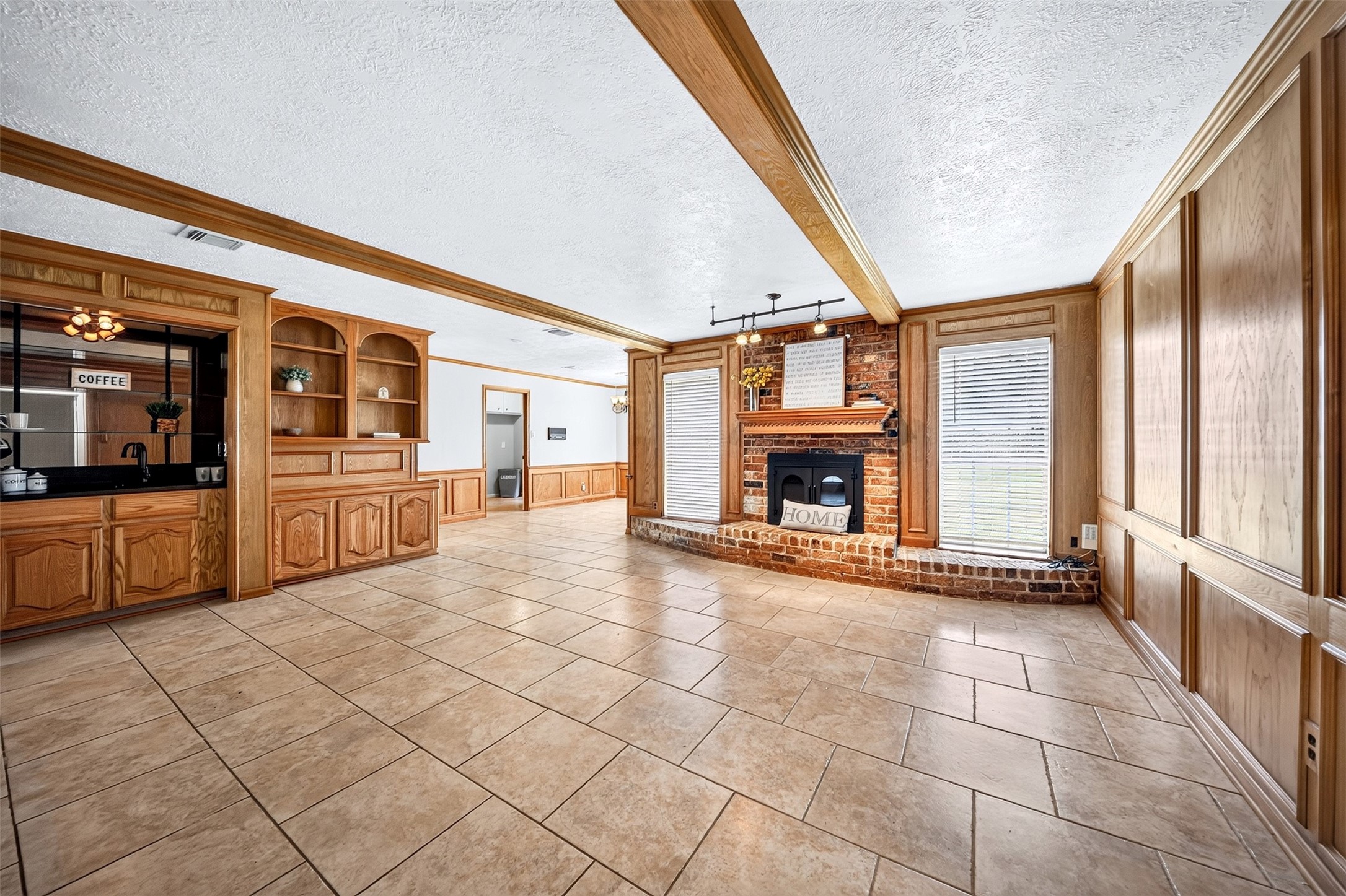 6507 Spring Leaf Drive Spring, TX 77379 - Photo 3 of 50 Step into this expansive living area designed for both comfort and entertainng, featuring beautiful tile flooring and timeless wood accents throughout.