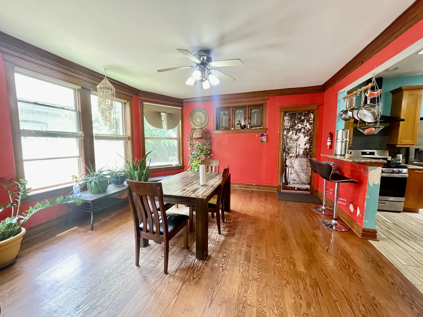 7916 South Constance Avenue Chicago, IL 60617 - Photo 10 of 28 a view of a dining room with furniture a chandelier and wooden floor