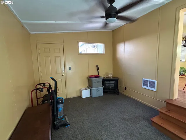 a dining room with furniture and a floor to ceiling window