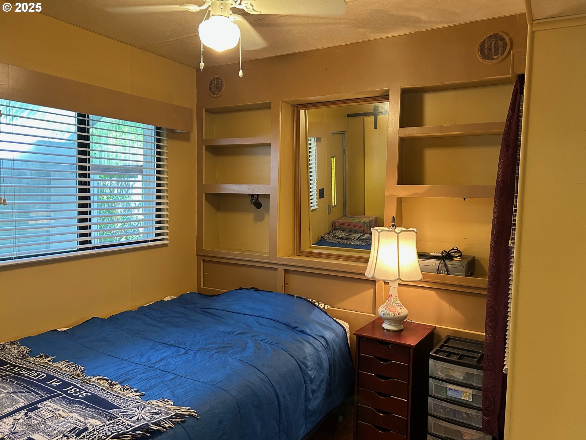 238 Horseshoe Bend Florence, OR 97439 - Photo 22 of 26 a bedroom with a bed and a chandelier