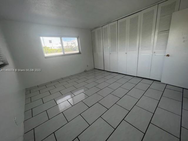 1857 Jefferson Street, Unit 306 Hollywood, FL 33020 - Photo 15 of 23 an empty room with windows