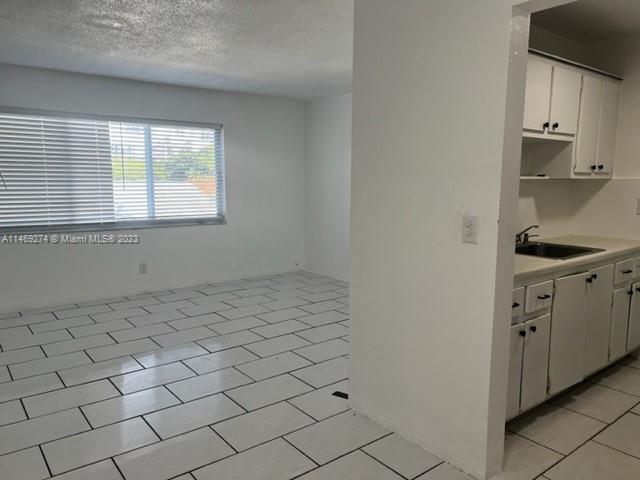1857 Jefferson Street, Unit 306 Hollywood, FL 33020 - Photo 17 of 23 a view of a kitchen with white cabinets