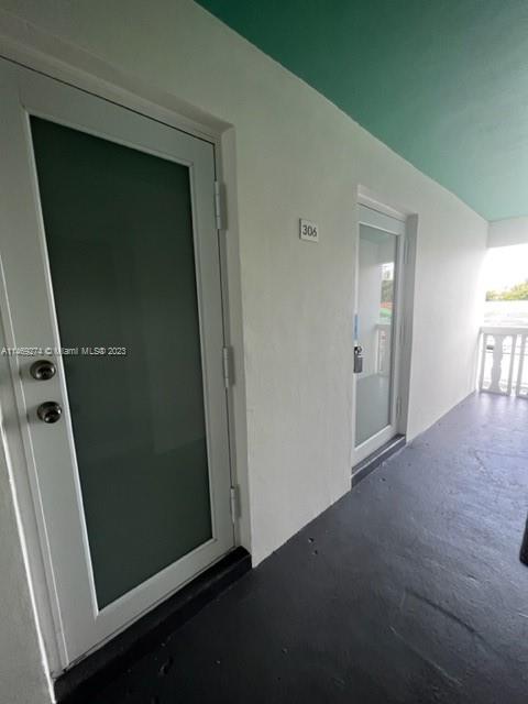 1857 Jefferson Street, Unit 306 Hollywood, FL 33020 - Photo 20 of 23 an empty room with windows