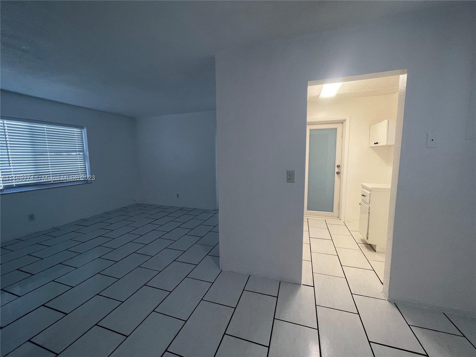 1857 Jefferson Street, Unit 306 Hollywood, FL 33020 - Photo 4 of 23 a view of an empty room and window