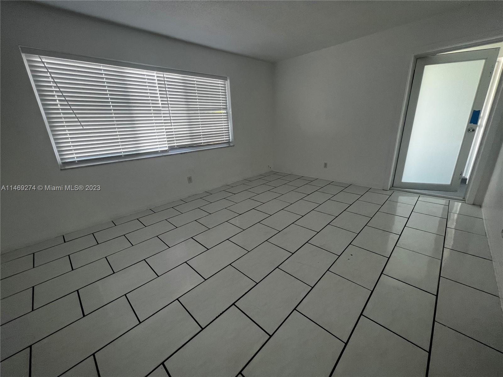 1857 Jefferson Street, Unit 306 Hollywood, FL 33020 - Photo 6 of 23 a view of a livingroom and window