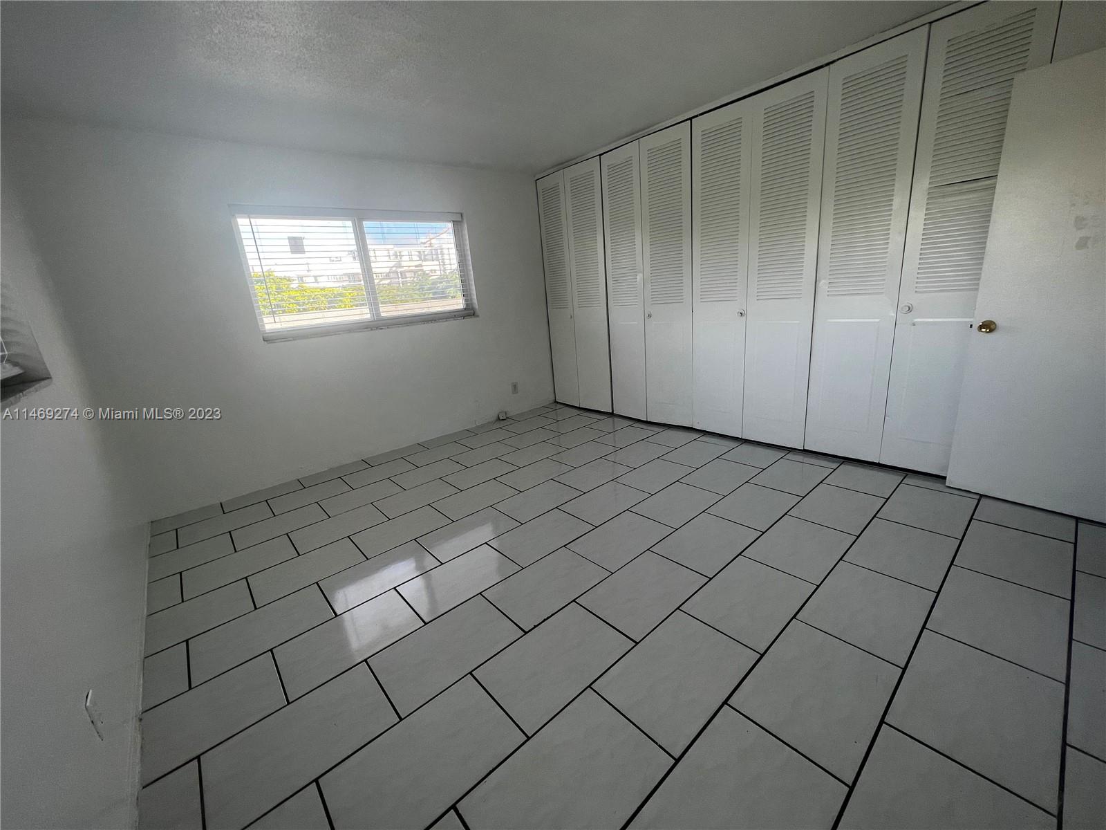 1857 Jefferson Street, Unit 306 Hollywood, FL 33020 - Photo 9 of 23 an empty room with windows