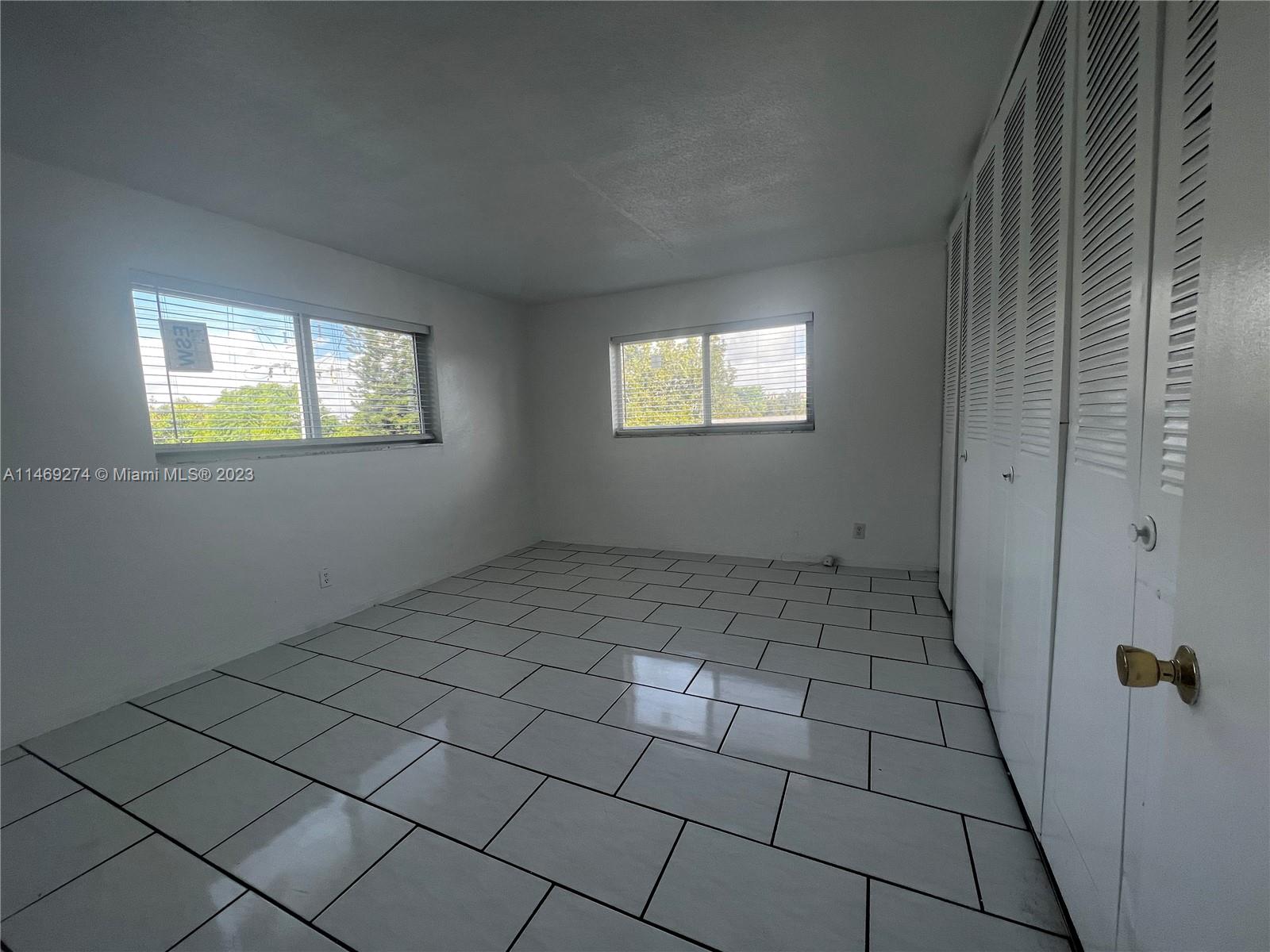 1857 Jefferson Street, Unit 306 Hollywood, FL 33020 - Photo 10 of 23 an empty room with windows