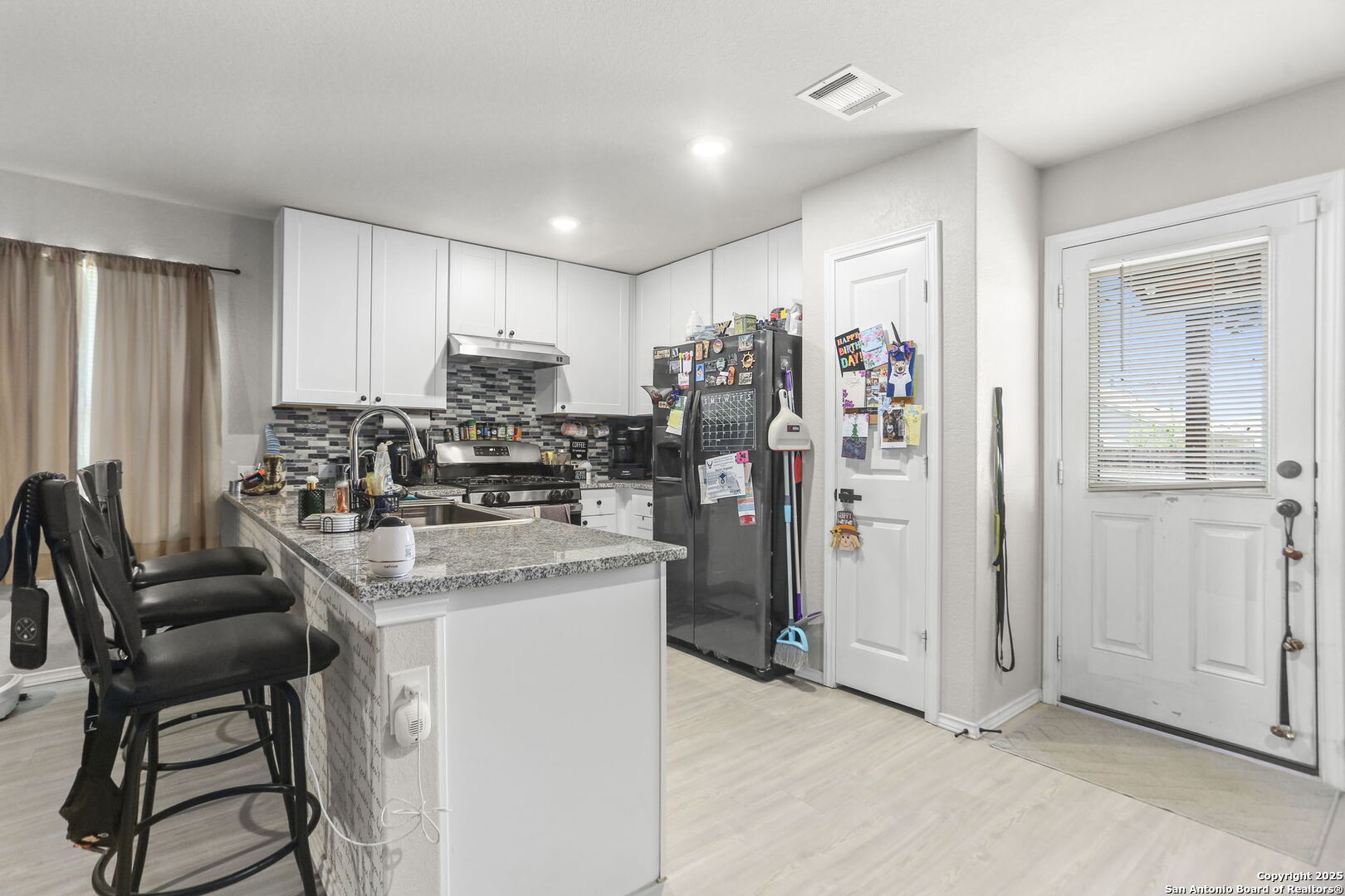 11910 Pewee San Antonio, TX 78221 - Photo 6 of 18 a kitchen with stainless steel appliances granite countertop a stove refrigerator and a refrigerator