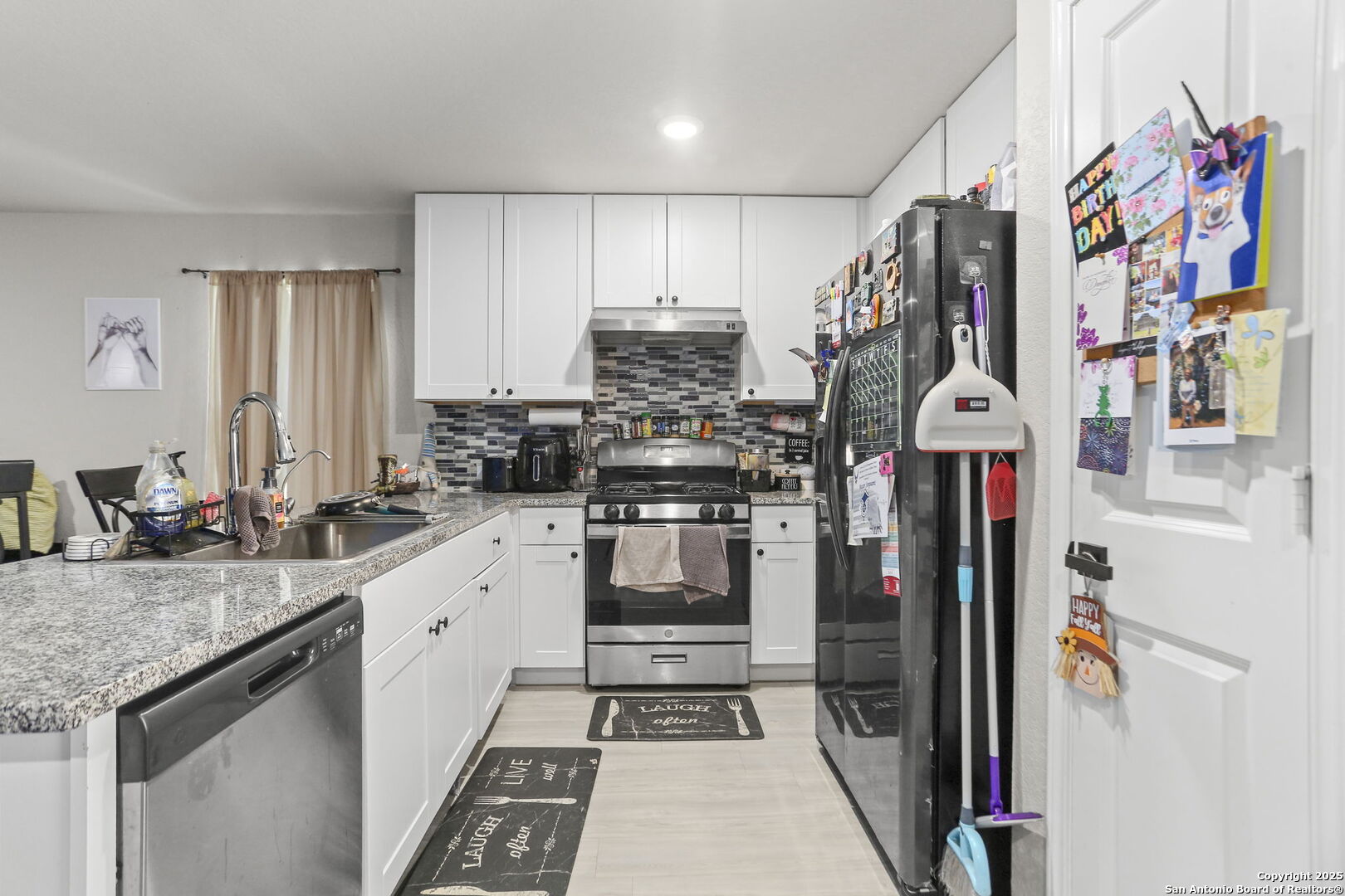 11910 Pewee San Antonio, TX 78221 - Photo 7 of 18 a kitchen with stainless steel appliances granite countertop a refrigerator and a sink
