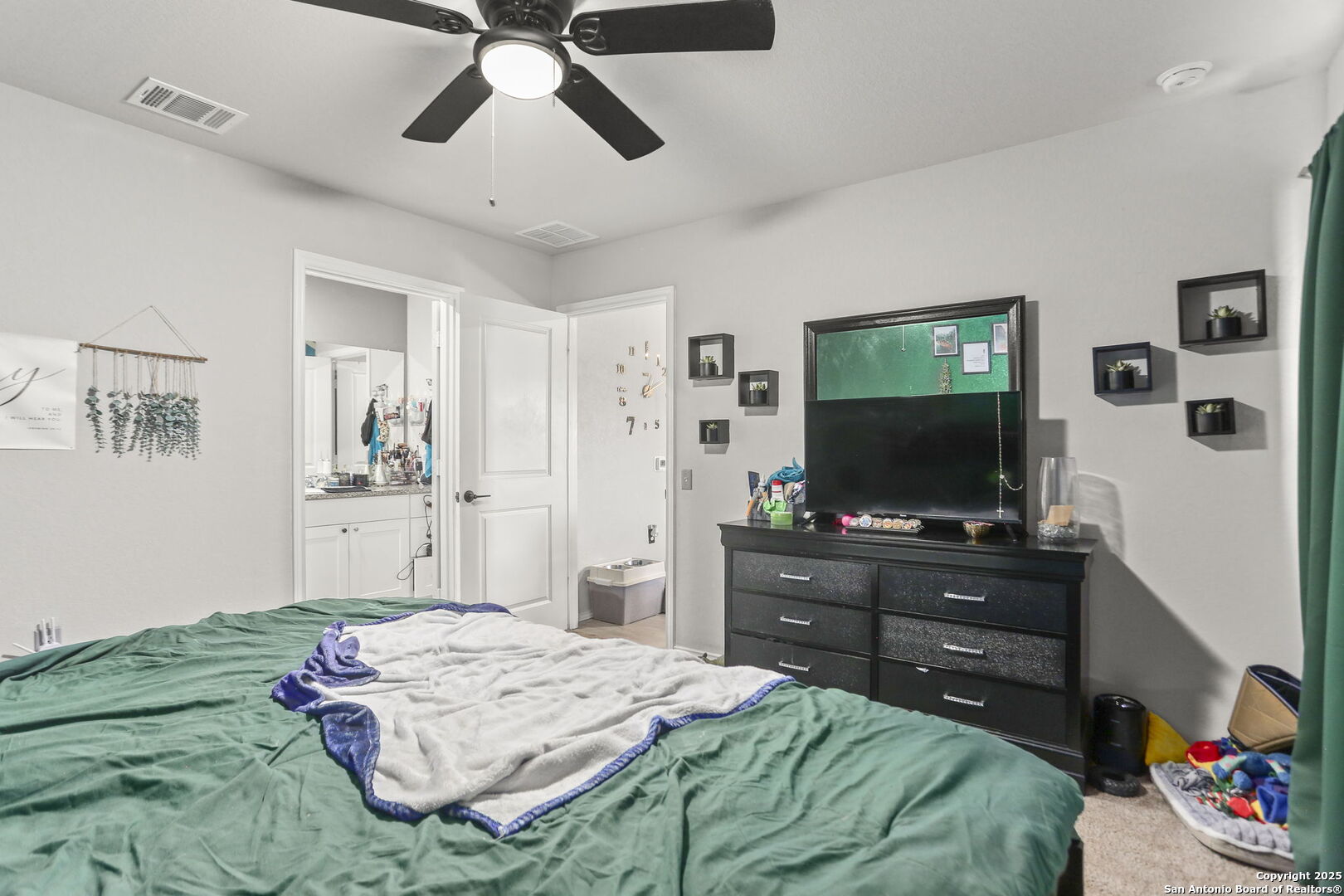 11910 Pewee San Antonio, TX 78221 - Photo 10 of 18 a bedroom with a bed and a flat screen tv