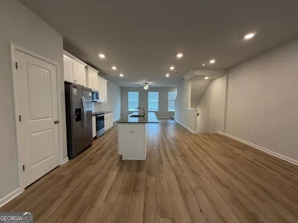 a large kitchen with stainless steel appliances kitchen island a large counter top and a sink