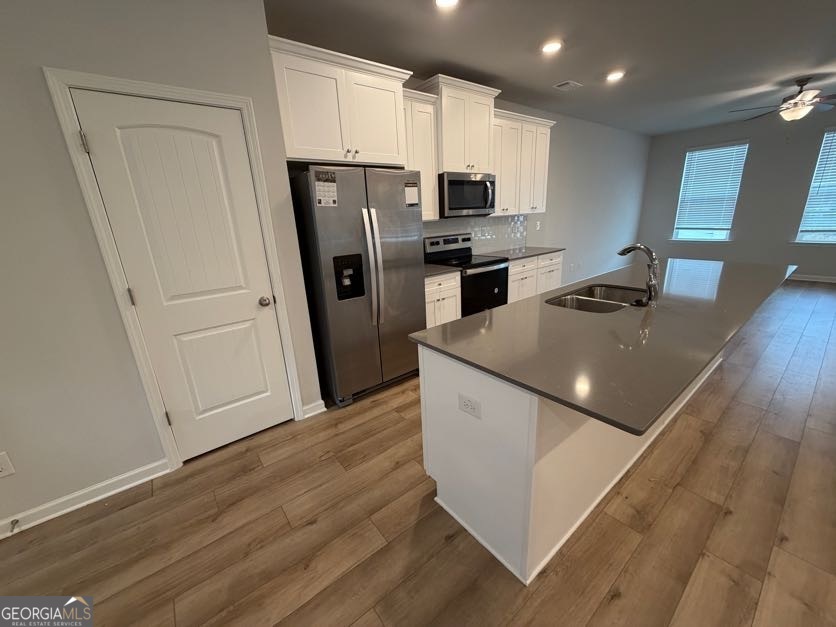 822 Werner Brook Way Southwest Atlanta, GA 30354 - Photo 24 of 55 a kitchen with refrigerator cabinets and wooden floor