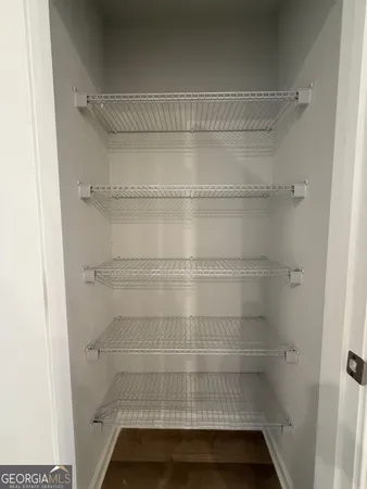 a view of a kitchen with a sink and dishwasher a refrigerator with wooden floor