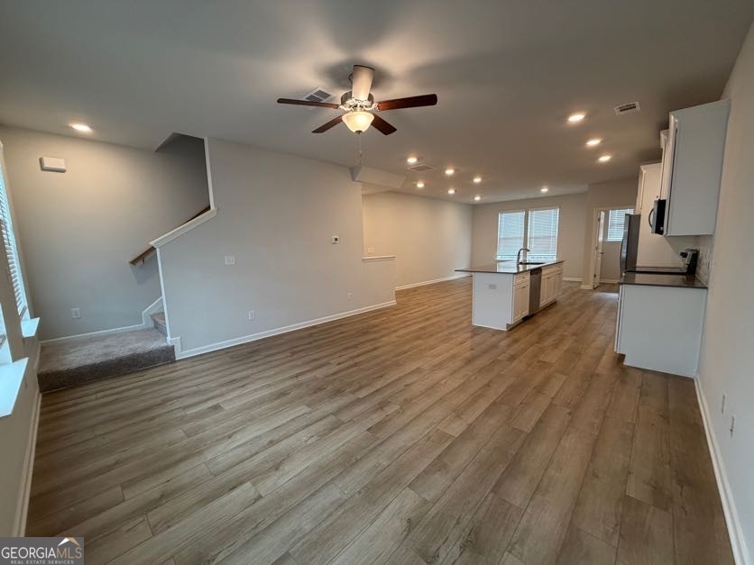822 Werner Brook Way Southwest Atlanta, GA 30354 - Photo 28 of 55 a view of a kitchen with a sink and dishwasher a refrigerator with wooden floor