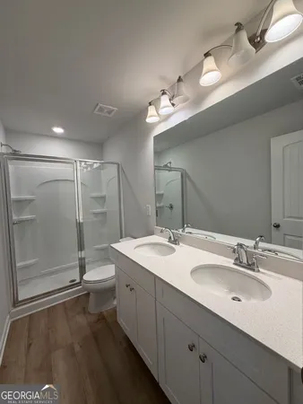 a bathroom with a glass shower door