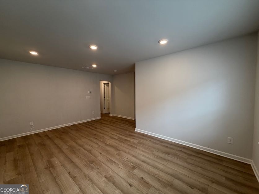 822 Werner Brook Way Southwest Atlanta, GA 30354 - Photo 5 of 55 an empty room with wooden floor and windows