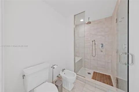 a bathroom with a toilet and shower