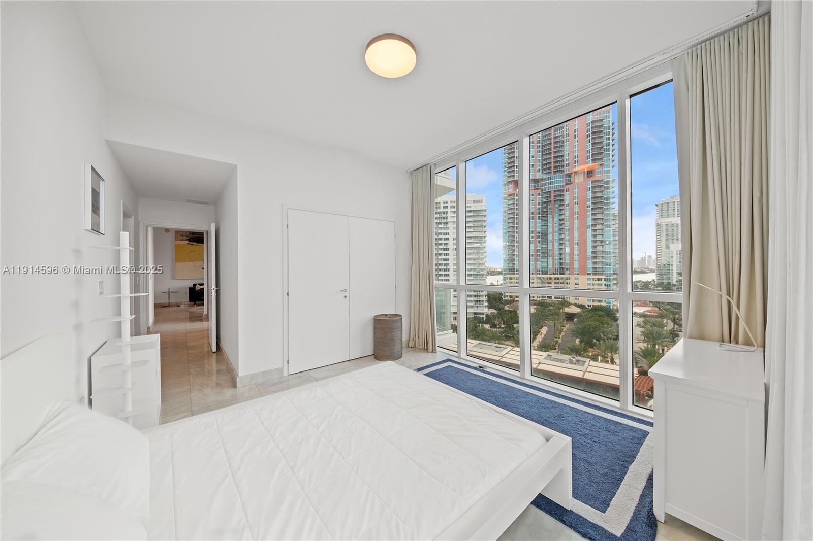50 South Pointe Drive, Unit 1206 Miami Beach, FL 33139 - Photo 23 of 38 a bedroom with a bed and a large window