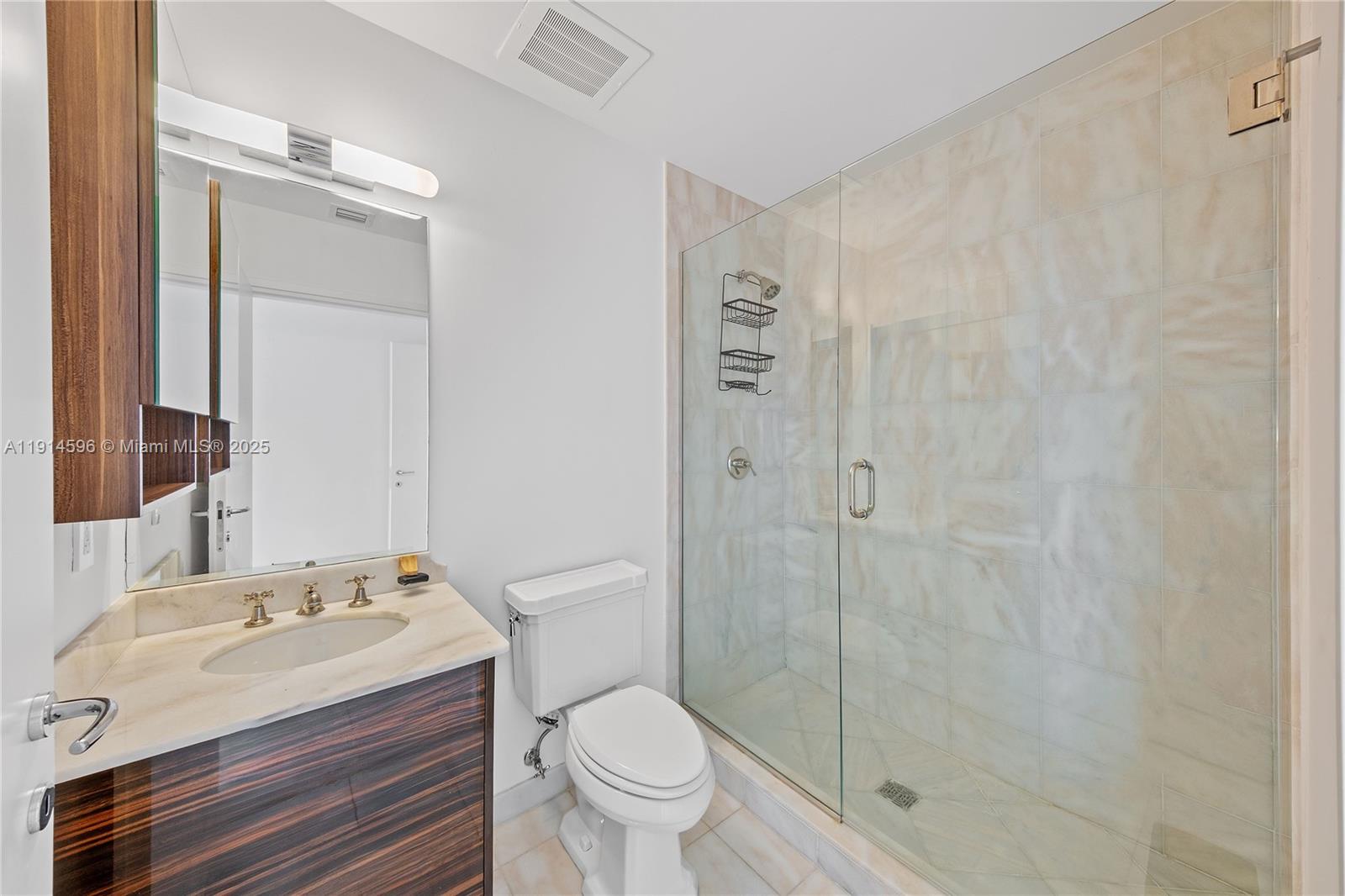 50 South Pointe Drive, Unit 1206 Miami Beach, FL 33139 - Photo 27 of 38 a bathroom with a granite countertop sink toilet and shower