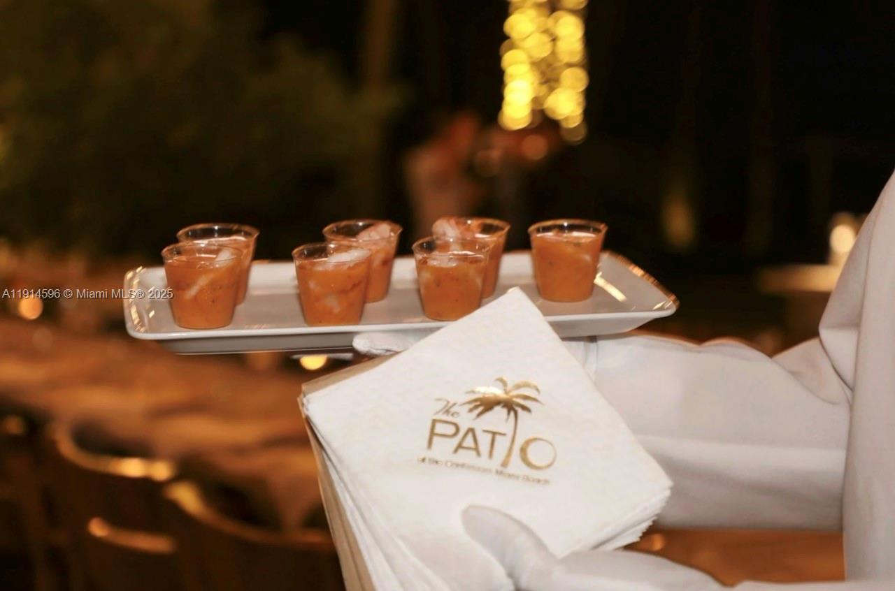 50 South Pointe Drive, Unit 1206 Miami Beach, FL 33139 - Photo 37 of 38 a table with chairs and a lamp on table