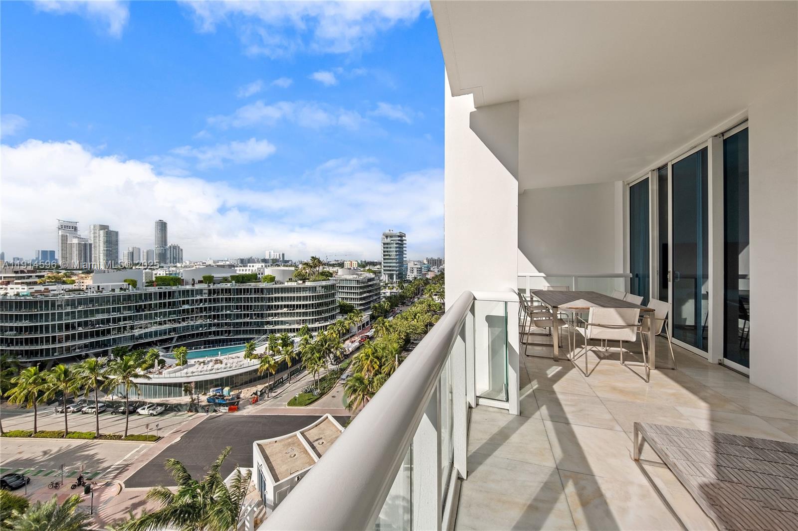 50 South Pointe Drive, Unit 1206 Miami Beach, FL 33139 - Photo 4 of 38 a balcony with outdoor seating and wooden floor