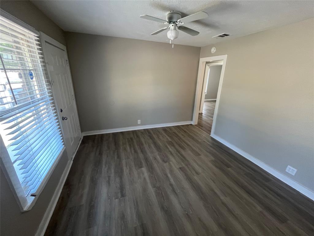1622 Centerville Road Dallas, TX 75228 - Photo 5 of 19 Wood-finish flooring, ceiling fan with integrated lighting, neutral wall paint, and white trim