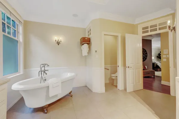 a spacious bedroom with a large bed and a fireplace
