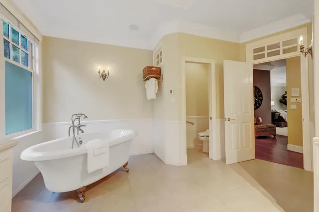 a living room with furniture a wooden floor and next to a window